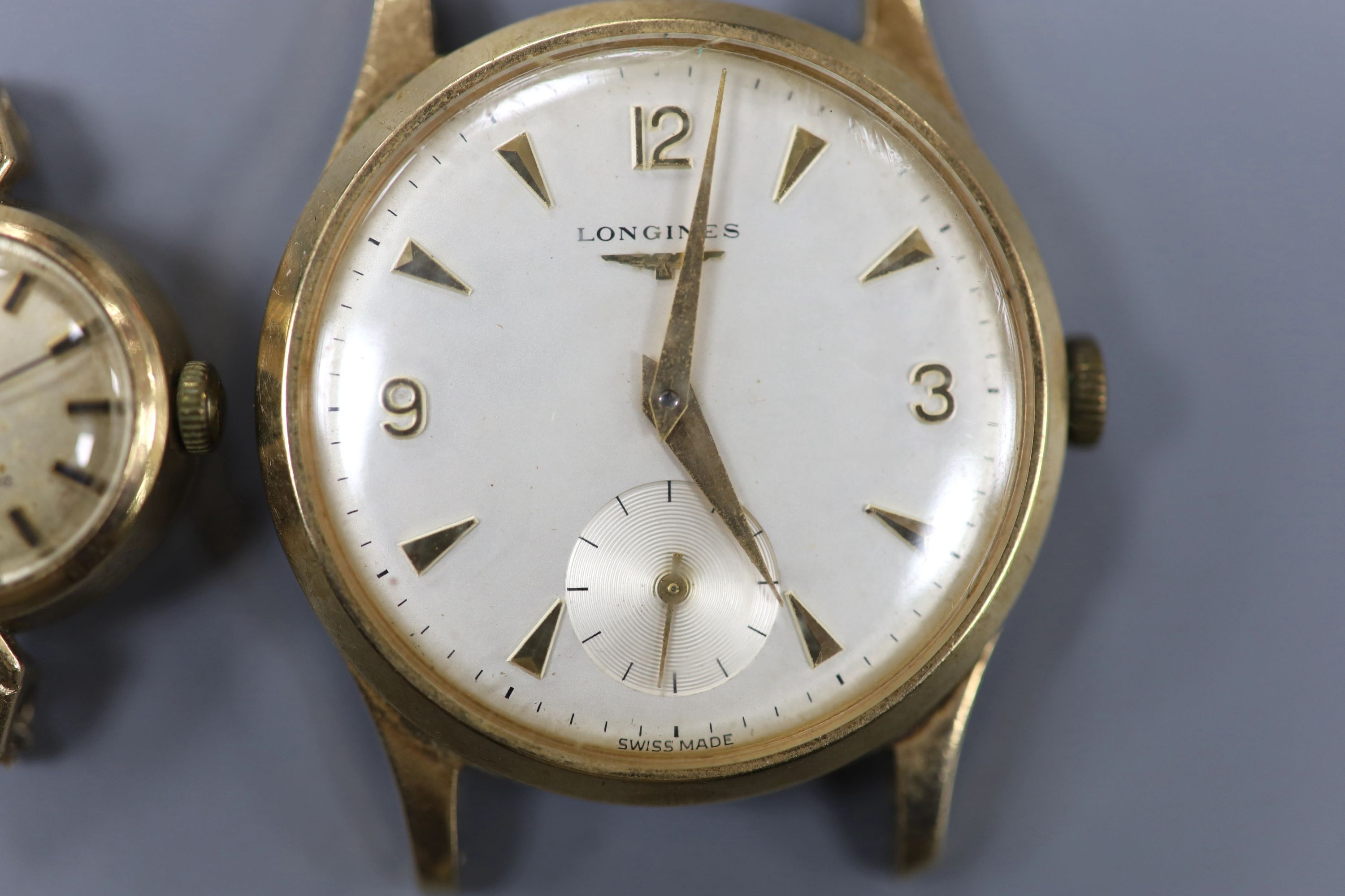 A gentleman's 9ct gold watch Longines manual wind wrist watch (no strap) and a lady's yellow metal Omega Ladymatic wrist watch (no strap), gross weight 39.5 grams.